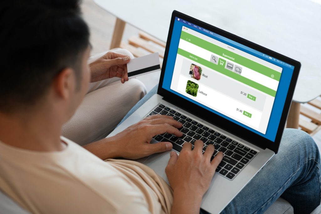 Digital marketer analyzing PPC campaign performance on a laptop with colorful charts and graphs.